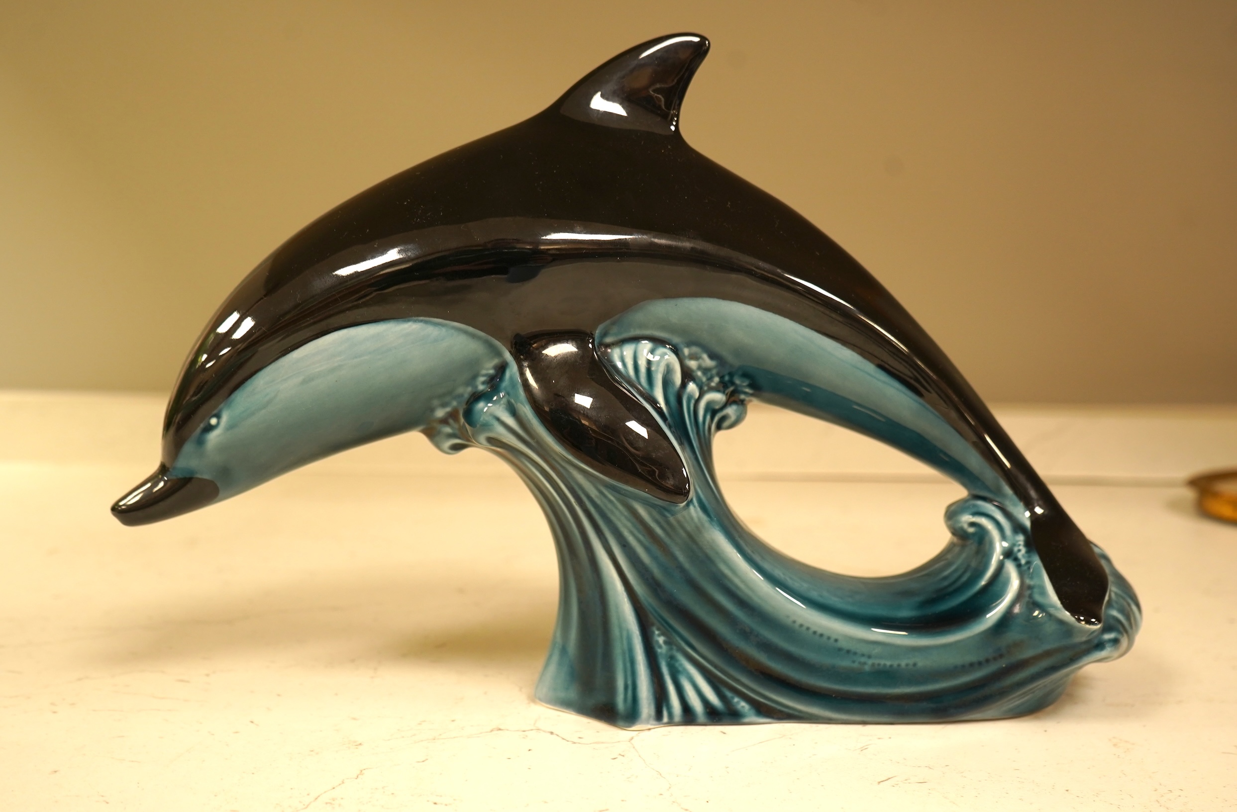 A Poole Pottery hors d’ouevres dish, a dolphin, a box and cover and a Torquay ware Brixham jar